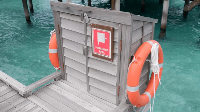 A lifebuoy on a wooden pier by the sea