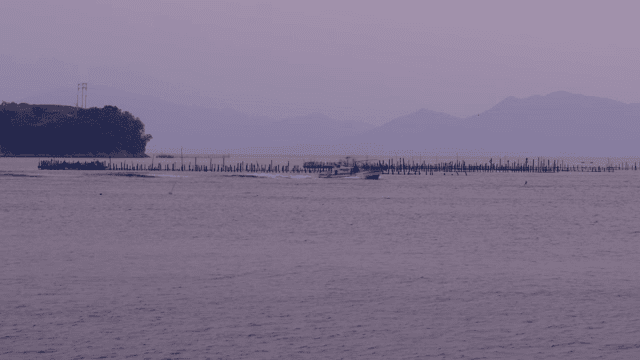 Fishing boat near aquaculture farm at sea