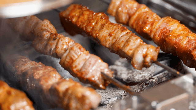 Lamb skewers grilled over charcoal
