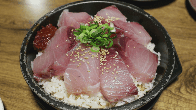 Bowl of rice topped with fresh sashimi
