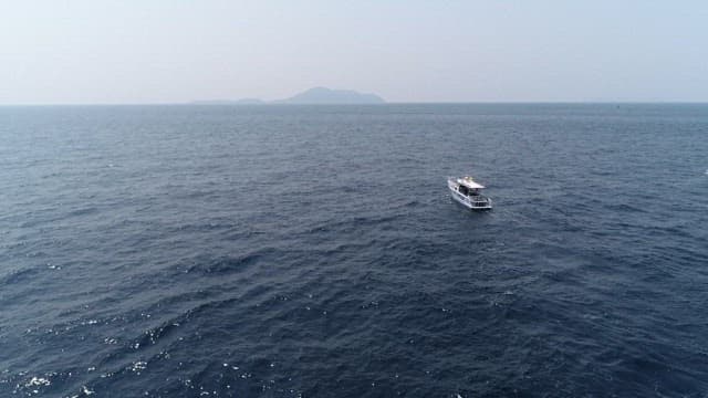 Boat cutting through ocean waves