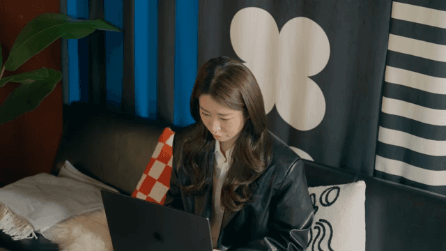 Woman lost in deep thought while working on her laptop