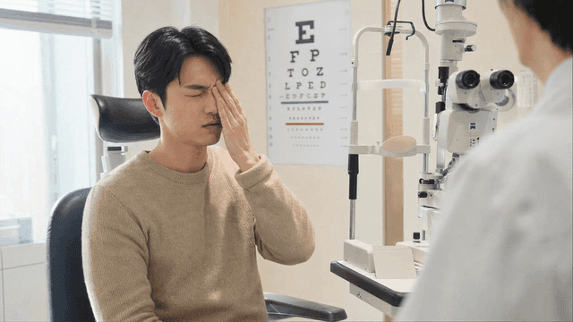 Male patient in pain with his eyes covered at clinic