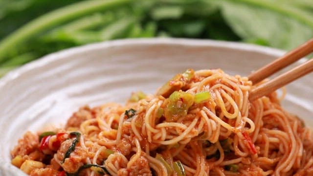 그릇에 담긴 매운 열무 비빔국수 한 젓가락