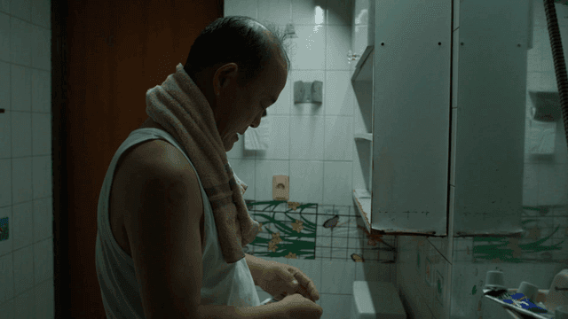 Man taking medicine in bathroom