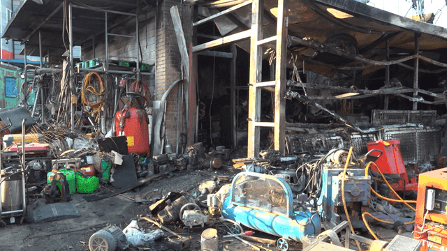 Burnt industrial site with scattered debris