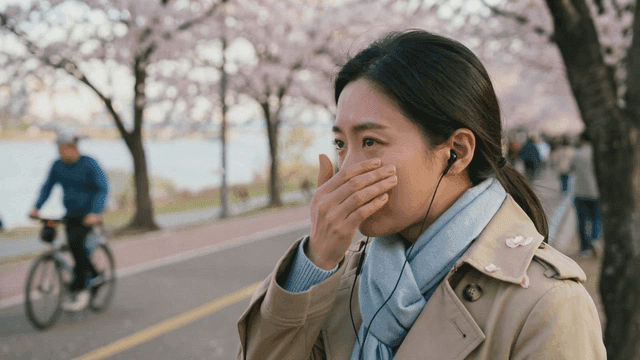 Woman crying under cherry blossoms