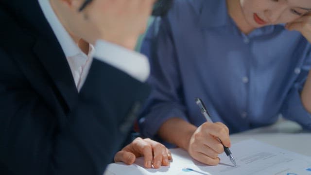 Two people discussing documents