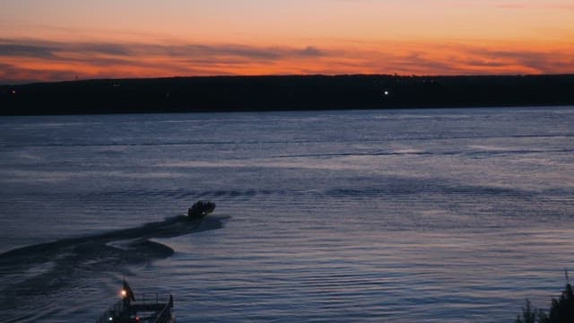 Speedboat riding through the river at sunset.