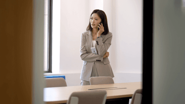 Female office worker on phone in conference room