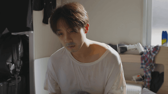 Man waking up in a sunlit room