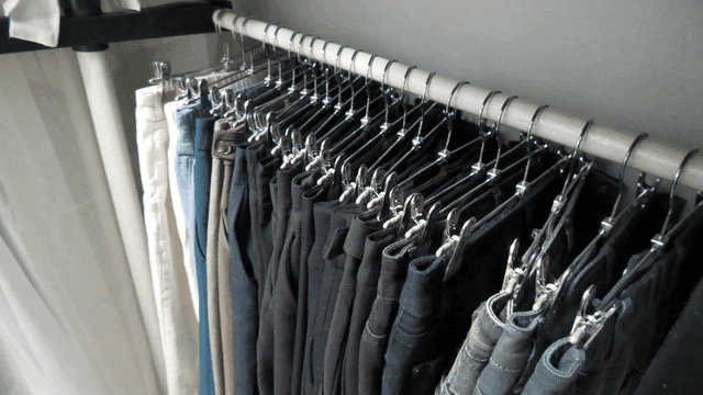 Various pants hanging on a rack