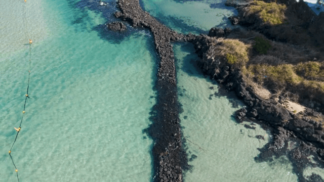 Rocky pier extending into clear waters