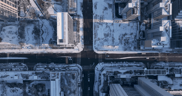 Snow-covered city intersection and buildings