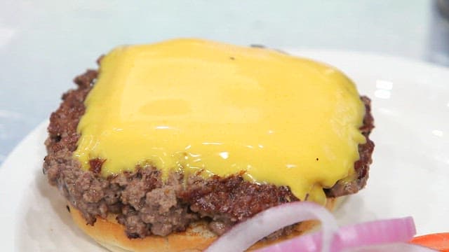 Cheeseburger topped with caramelized onions