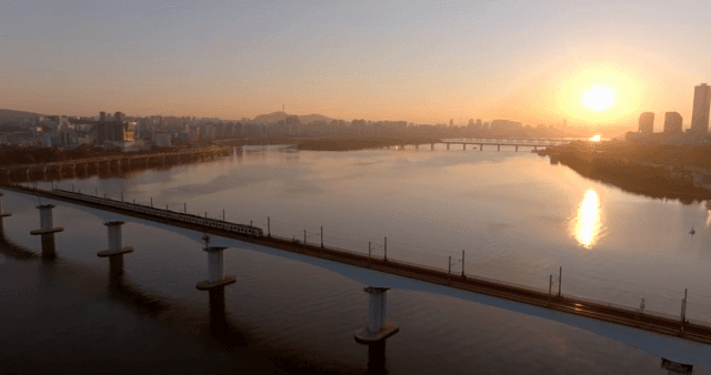 Sunset over a city skyline and river