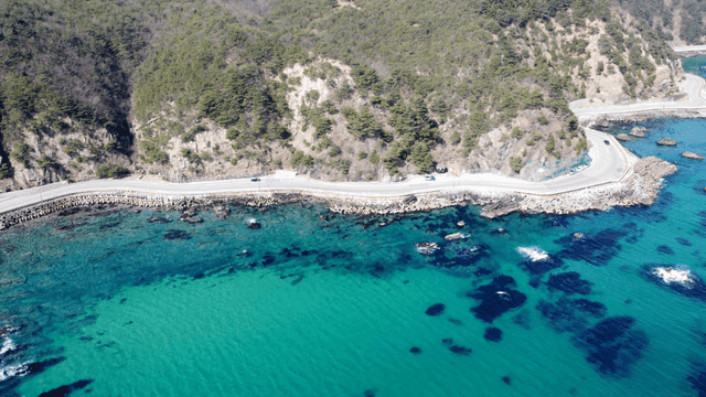 Coastal road alongside a clear blue sea