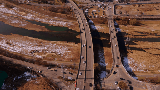 Roads continuing over fields