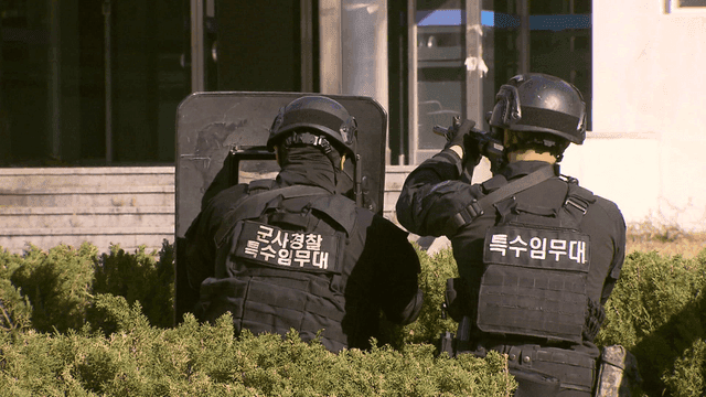 Special forces in tactical gear outside a building