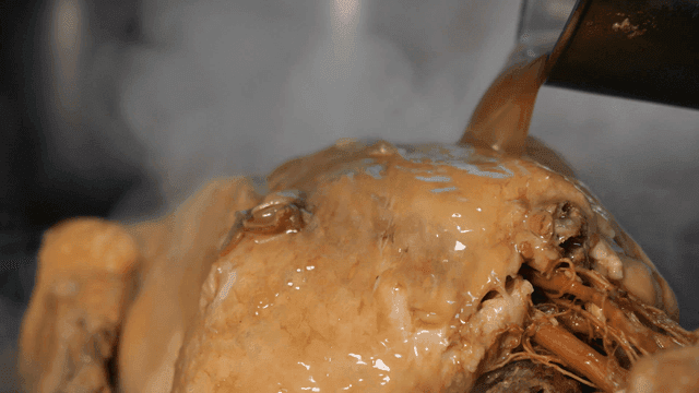 Steaming samgyetang with broth pouring