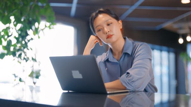 Woman working on a laptop in a modern office