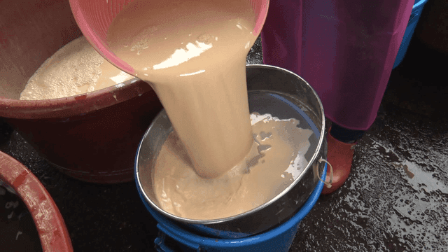 Straining liquid scooped from a basin through a sieve
