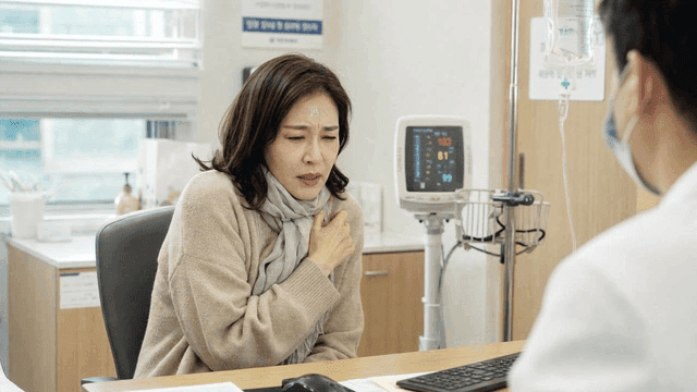 Middle-aged female patient with high fever consulting with doctor at hospital