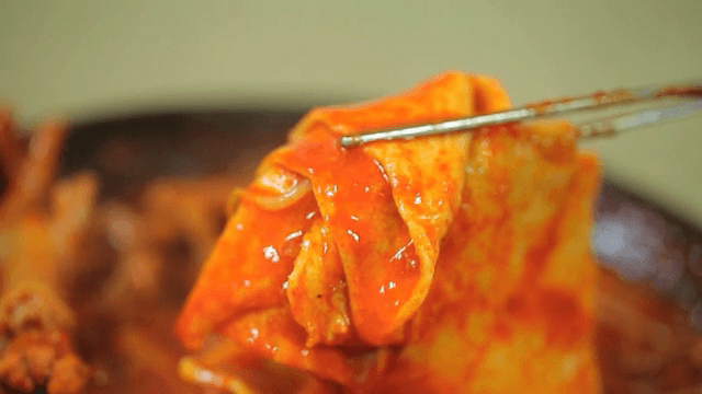 Spicy braised chicken feet in sauce with fish cake
