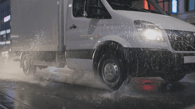 Truck driving on rainy road
