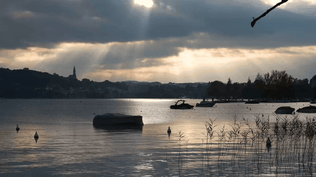 Serene lake with boats and distant hills