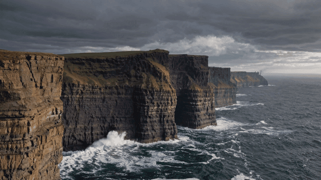 Majestic cliffs by the ocean under a cloudy sky