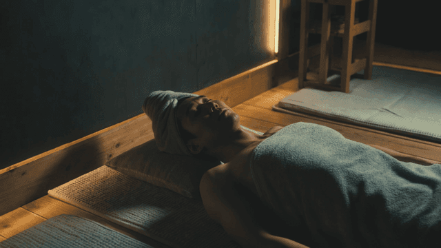 Man relaxing at spa with towel wrapped around him