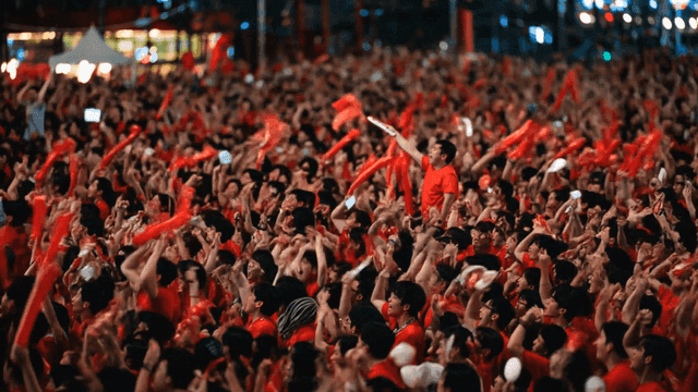 Large crowds cheering outdoors