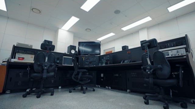 Technician Working in a Modern Control Room