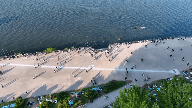 Bustling riverside promenade with people