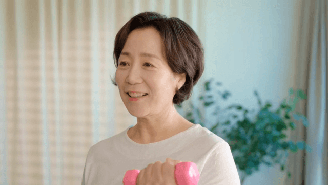 Woman exercising with dumbbells indoors