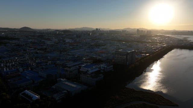 Sunset Over Urban Landscape and Sea