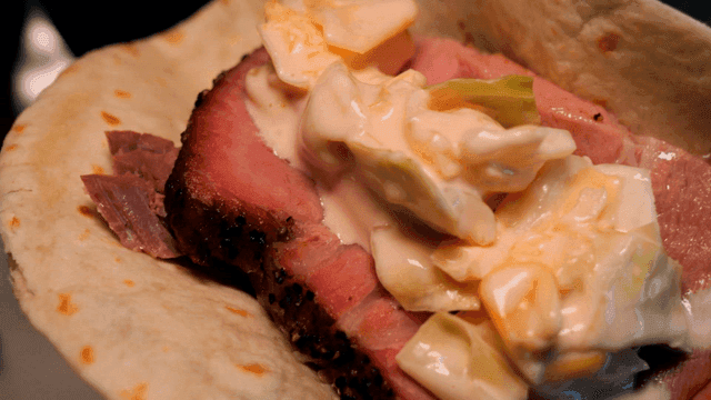 Tortilla wrap with smoked barbecue meat and salad