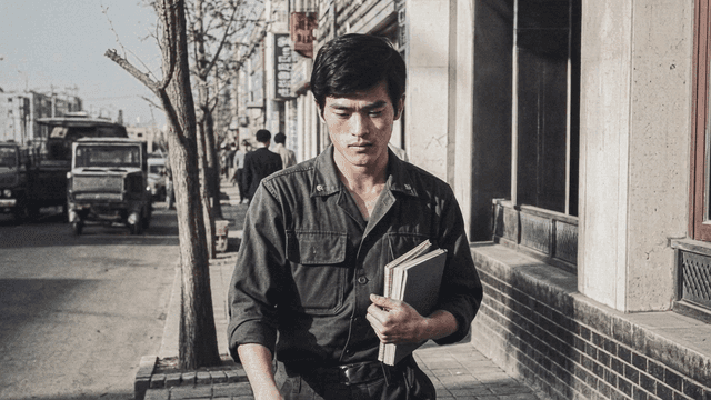 Man walking down street holding book in 70s