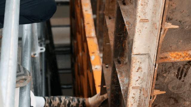 Worker adjusting metal framework