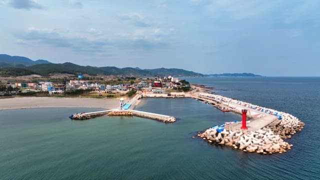 Coastal village with a lighthouse and pier