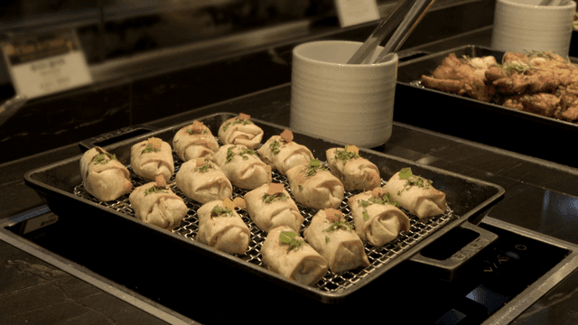 Tray of dumplings with famous name on it at buffet