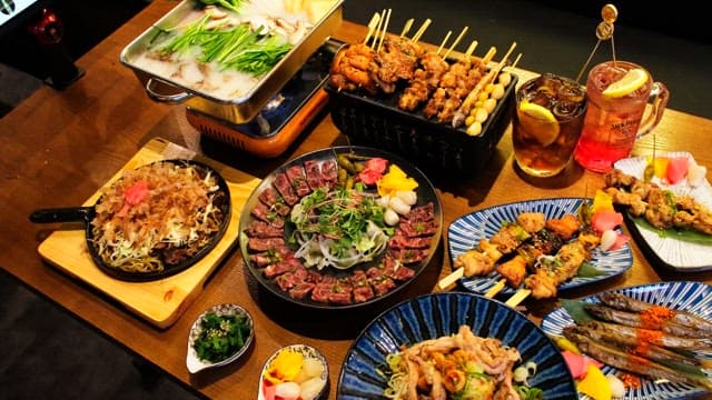 Table generously laid out with a variety of Japanese cuisine