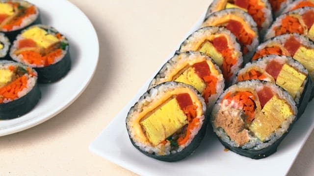 Several Types of Gimbap Served on a White Plate