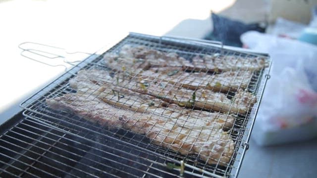 Appetizing pork belly being grilled on a barbecue grill