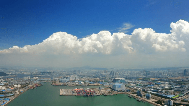 Vast port city landscape under a picturesque sky