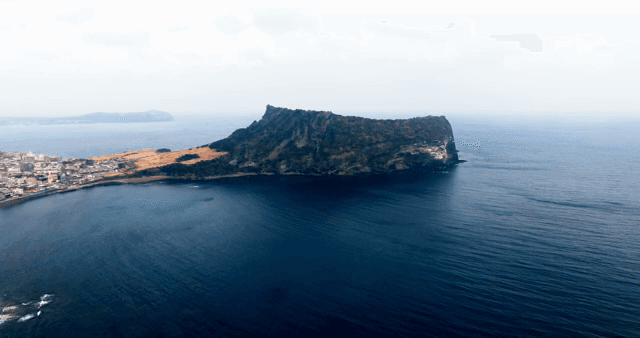 Scenic Seongsan Ilchulbong Tuff Cone surrounded by the sea