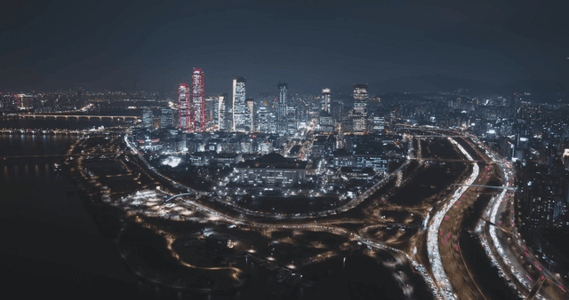 Parliament building with bustling city skyline at night