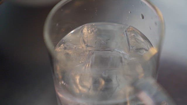 Pouring Espresso into Cup with Ice