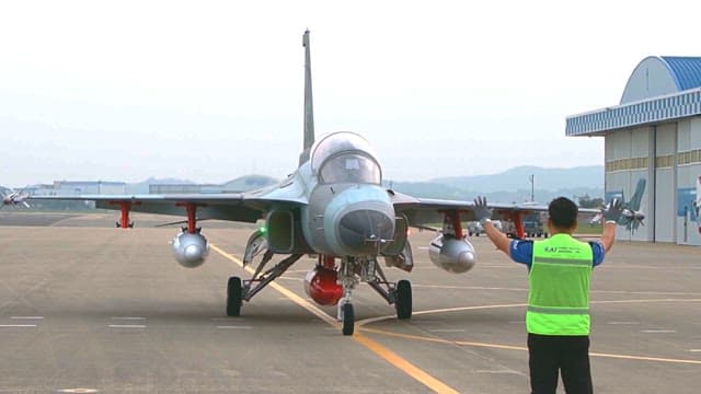 Aircraft is guided by an airport marshal on the runway